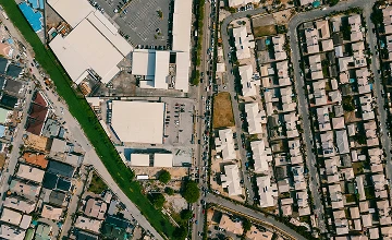 Top-down view of a town featuring various commercial projects and urban development.